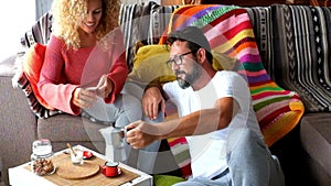 Happy adult caucasian couple at home enjoy breakfast together - autumn season and indoor leisure activity for man and woman in the