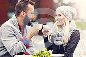 Happy adult couple dating in cafe