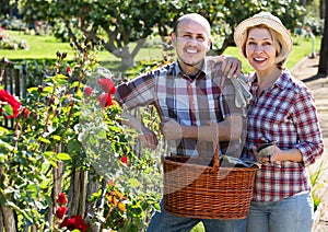 Happy adult couple engaged in gardening