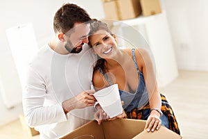 Happy adult couple moving out or in to new home