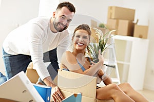 Happy adult couple moving out or in to new home