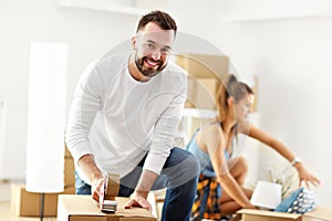 Happy adult couple moving out or in to new home