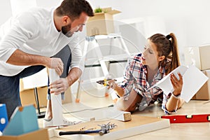 Happy adult couple moving out or in to new home