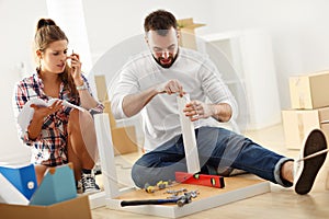 Happy adult couple moving out or in to new home