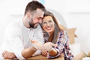Happy adult couple moving out or in to new home