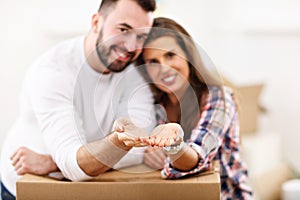 Happy adult couple moving out or in to new home