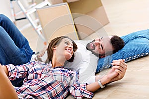 Happy adult couple moving out or in to new home