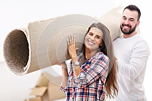 Happy adult couple moving out or in to new home