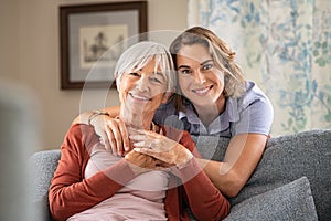 Happy adult daughter embracing senior mother