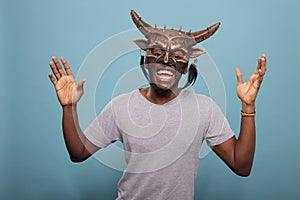 Happy adult wearing tribal native ceremonial face mask