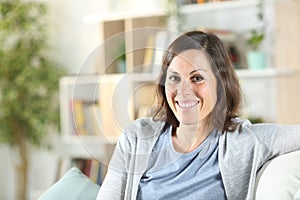 Happy adult woman posing looking camera at home