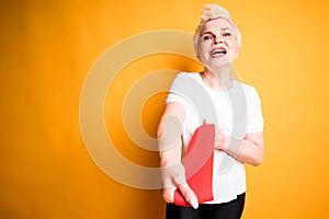 Happy adult woman smiles broadly and stretches an elastic band to the camera for training