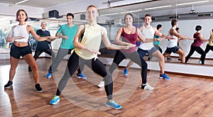 Happy adults having group fitness class