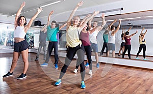 Happy adults having group fitness class