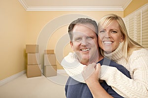 Happy Affectionate Couple in Room of New House with Boxes