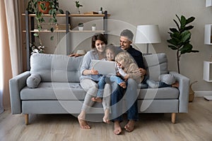 Happy affectionate family using computer applications.