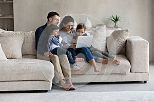 Happy affectionate loving hispanic family using computer at home.
