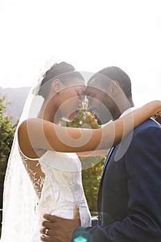 Happy african american bride and groom embracing at wedding in sunny garden, copy space