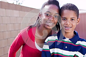 Happy African American brother and sister smiling.