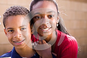 Happy African American brother and sister smiling.