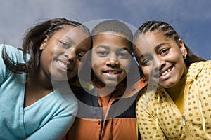 Happy African American brother and sisters smiling.