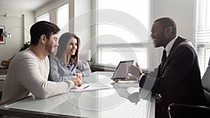 Happy african american businessman showing mockup on tablet.