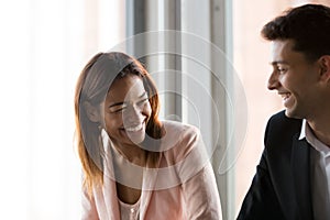 Happy African American businesswoman laughing at colleague joke