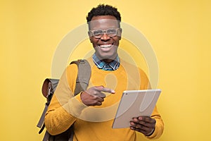 Happy african american college student holding table