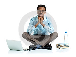 Happy african american college student sitting with laptop on wh