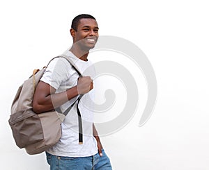 Happy african american college student walking