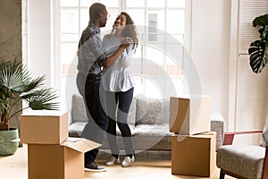 Happy African American couple dancing after moving photo