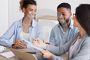 Happy African American Couple Discussing Dream Vacation With Travel Agent