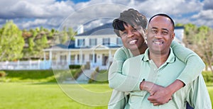 Happy African American Couple In Front of Beautiful House.