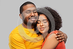 Happy african american couple hugging