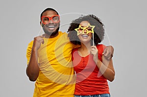 Happy african american couple with party props