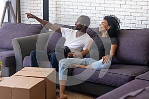 Happy African American couple planning renovation in new house