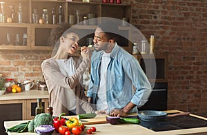 Happy african-american couple preparing dinner