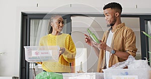 Happy african american couple recycling waste
