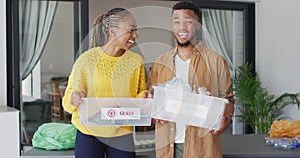 Happy african american couple recycling waste