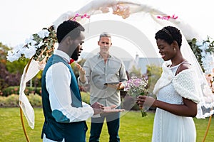 Happy african american couple with ring during wedding