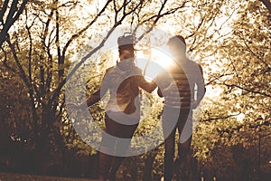 Happy African American couple running and catching in park