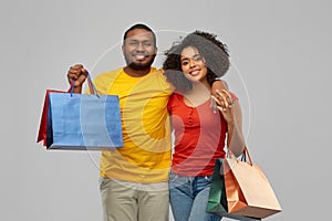 Happy african american couple with shopping bags