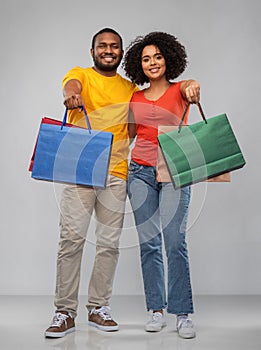 Happy african american couple with shopping bags