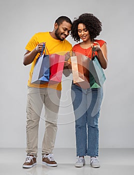 Happy african american couple with shopping bags