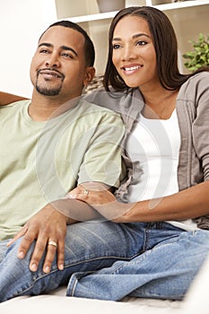 Happy African American Couple Sitting At Home