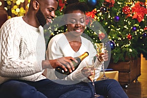 Happy african american couple toasting New Year`s Eve