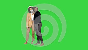 Happy African American couple walking and taking a selfie on a Green Screen, Chroma Key.