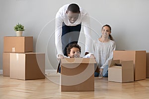 Happy african American dad playing with son on moving day