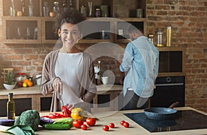 Happy african-american family cooking in loft kitchen
