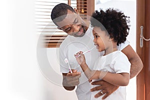 African American Family brushing teeth together photo